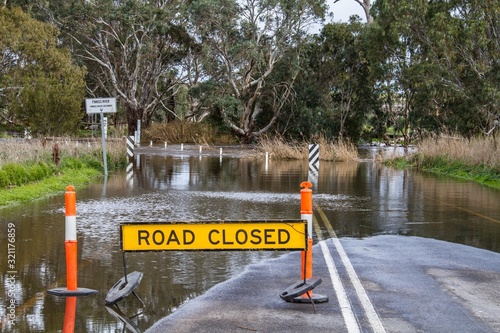 Road closed due to flooding showing road closed sign