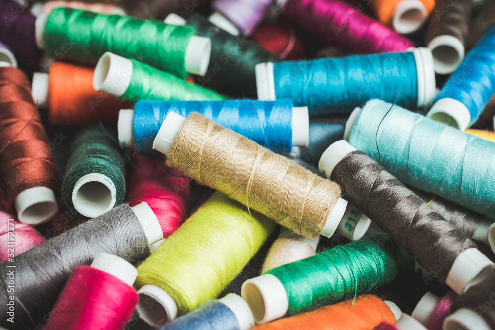 Color sewing threads close-up shot. Selective focus. Shallow depth of field. Color sewing threads close-up shot. Selective focus. Shallow depth of field.