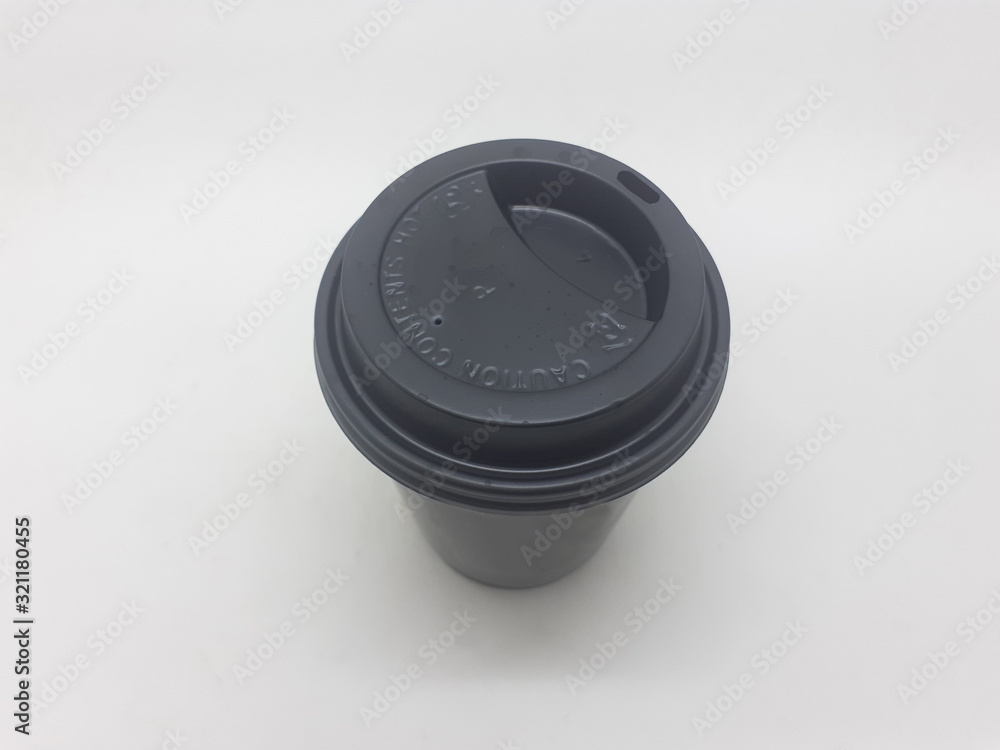 Black Colored Recycle Paper Glass with Cardboard Wrap Packaging and Plastic Cap Straw for Drive Through Beverages Service in White Isolated Background Black Colored Recycle Paper Glass with Cardboard Wrap Packaging and Plastic Cap Straw for Drive Through Beverages Service in White Isolated Background