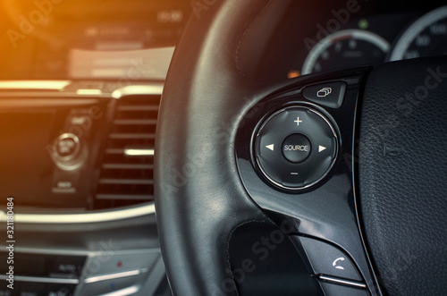 Multimedia button on multifunction steering wheel in a luxury car.