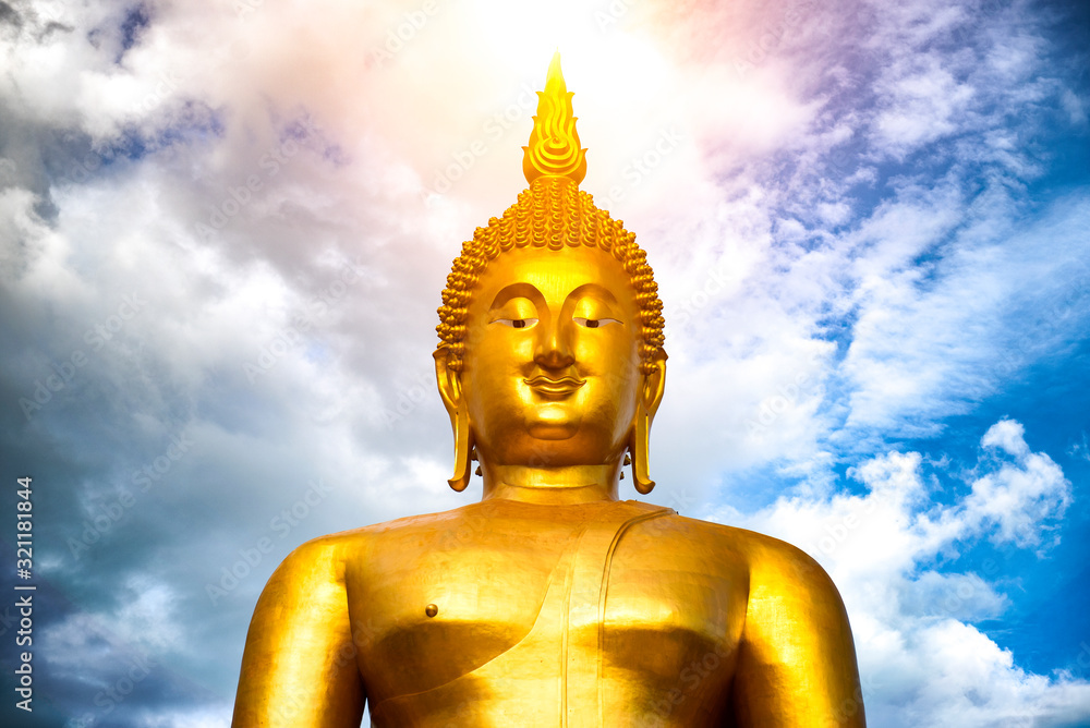 Makha Bucha Day, Visakha Bucha, a large shadow Buddha statue behind a golden sunset in Thailand Makha Bucha Day, Visakha Bucha, a large shadow Buddha statue behind a golden sunset in Thailand