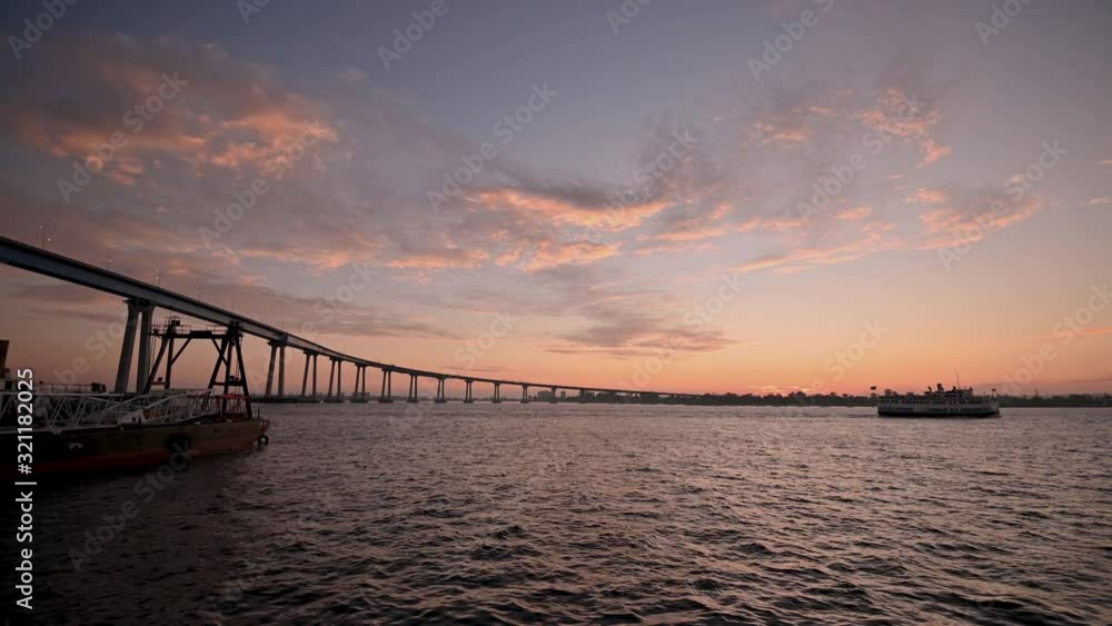 The Beautiful Scenery Of A Calm Sea and Long Bridge In Coronado During Sunset - Wide Shot The Beautiful Scenery Of A Calm Sea and Long Bridge In Coronado During Sunset - Wide Shot