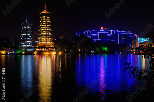Sun and Moon Pagodas and bank lights reflecting in Shanhu or Fir Lake at night in Guilin China