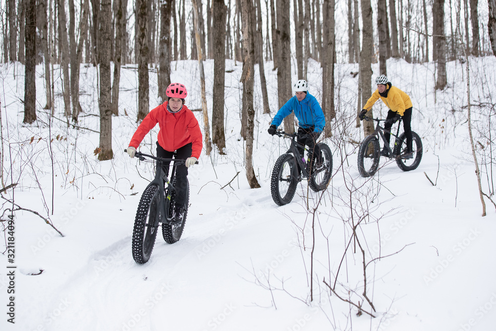 Group of friends riding their fat bike in the snow in Ontario, Canada