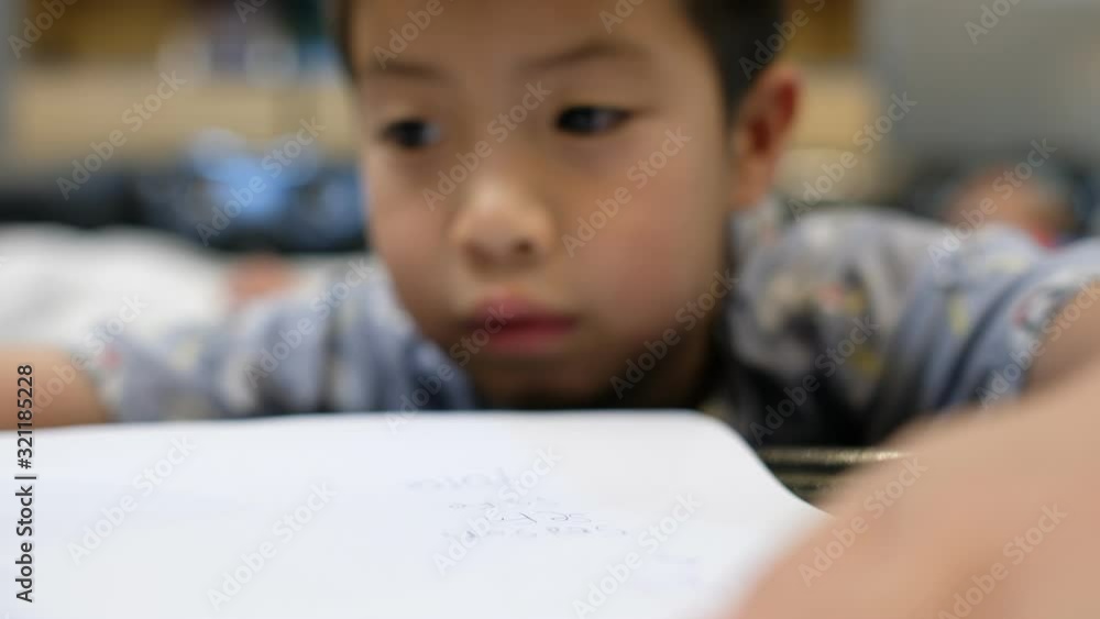 boy doing homework, kid writing paper boy doing homework, kid writing paper