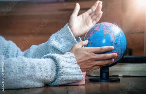 Close up hands praying for globe and people in the world, christian concept.
