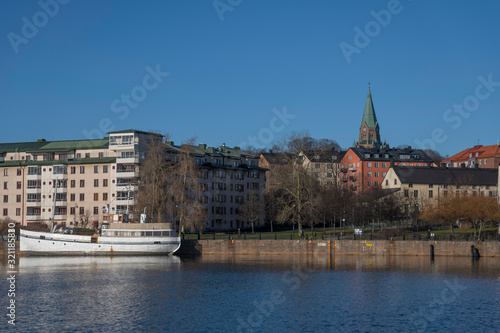 The Lake area Hammarby Sjöstad between the districts Södermalm, Hammarby and Sickla in Nacka. Stockholm a sunny winter day. Boats, piers and houses surrounding the lake area.