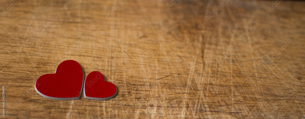 Valentine's Day card. Two red hearts on wooden background. Greeting card concept. Top view Valentine's Day card. Two red hearts on wooden background. Greeting card concept. Top view