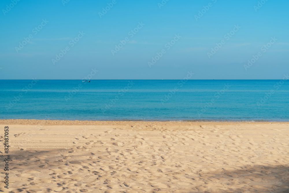 Tropical sea beach with sand, ocean and blue sky