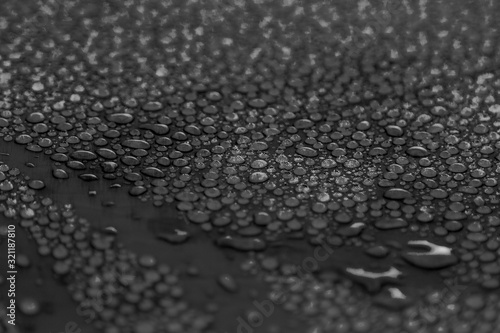 different drops of water on a black background