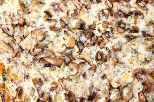 A top down view of a mushroom and cheese pizza.