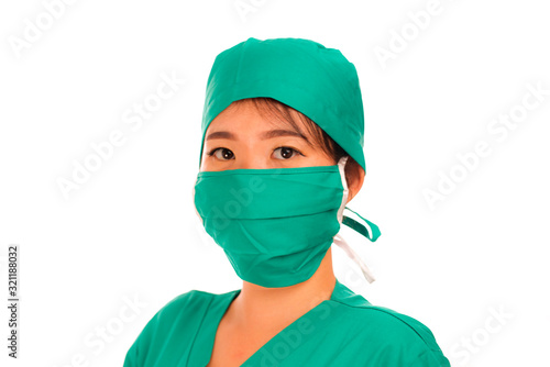  beautiful and serious Asian Chinese medicine doctor woman or hospital nurse in medical hat surgeon face mask and green scrub in virus treatment and health care concept