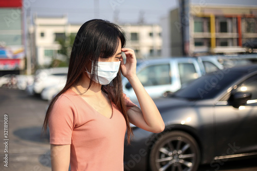  Beautiful asia woman wearing mouth mask against air smog pollution PM 2.5 and Coronavirus in the community,bangkok thailand. © keatikun