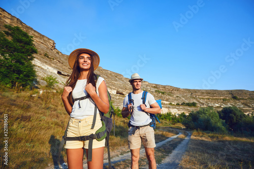 Couple hikers with backpack on hike in nature