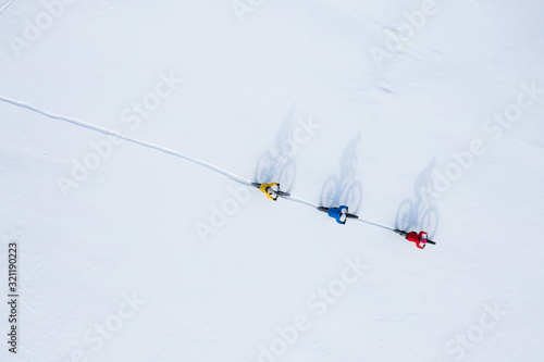 Obraz na płótnie Aerial drone photo of a group of friends riding their fat bike in the snow in Ontario, Canada w salonie