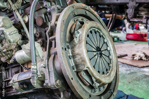 Old rusted car engine and clutch disc. photo