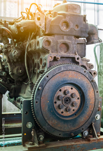 Old rusted car engine and clutch disc.