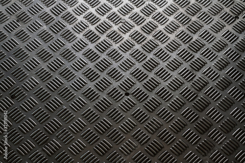 Background of seamless pattern and textured of the vintage steel checker plate with soft lighting.