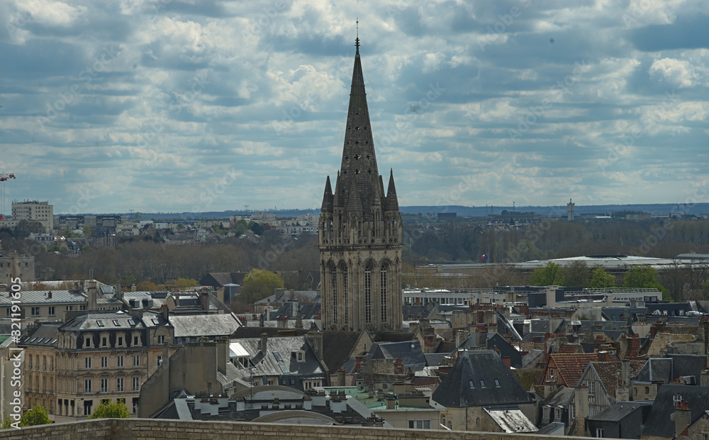 Cityscape of French city Caen with high tower of an catholic cathedral