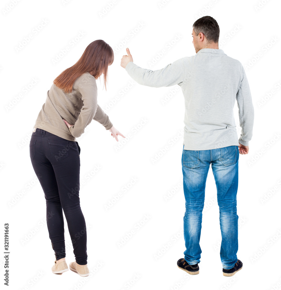 Back view of couple couple in sweater pointing. Back view of couple couple in sweater pointing.