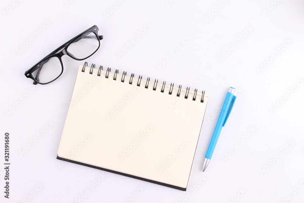 Top view blank notebook with pen on white background Top view blank notebook with pen on white background