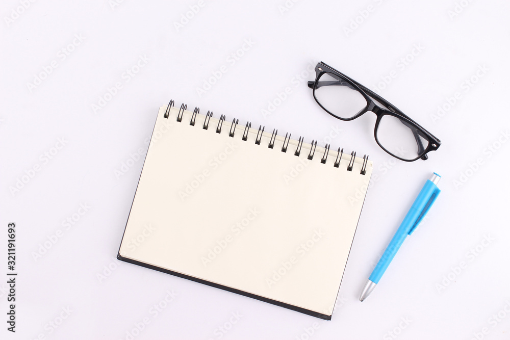 Top view blank notebook with pen on white background Top view blank notebook with pen on white background