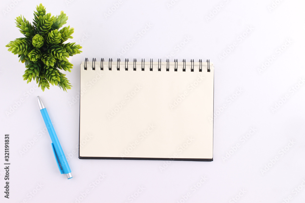 Top view blank notebook with pen on white background Top view blank notebook with pen on white background