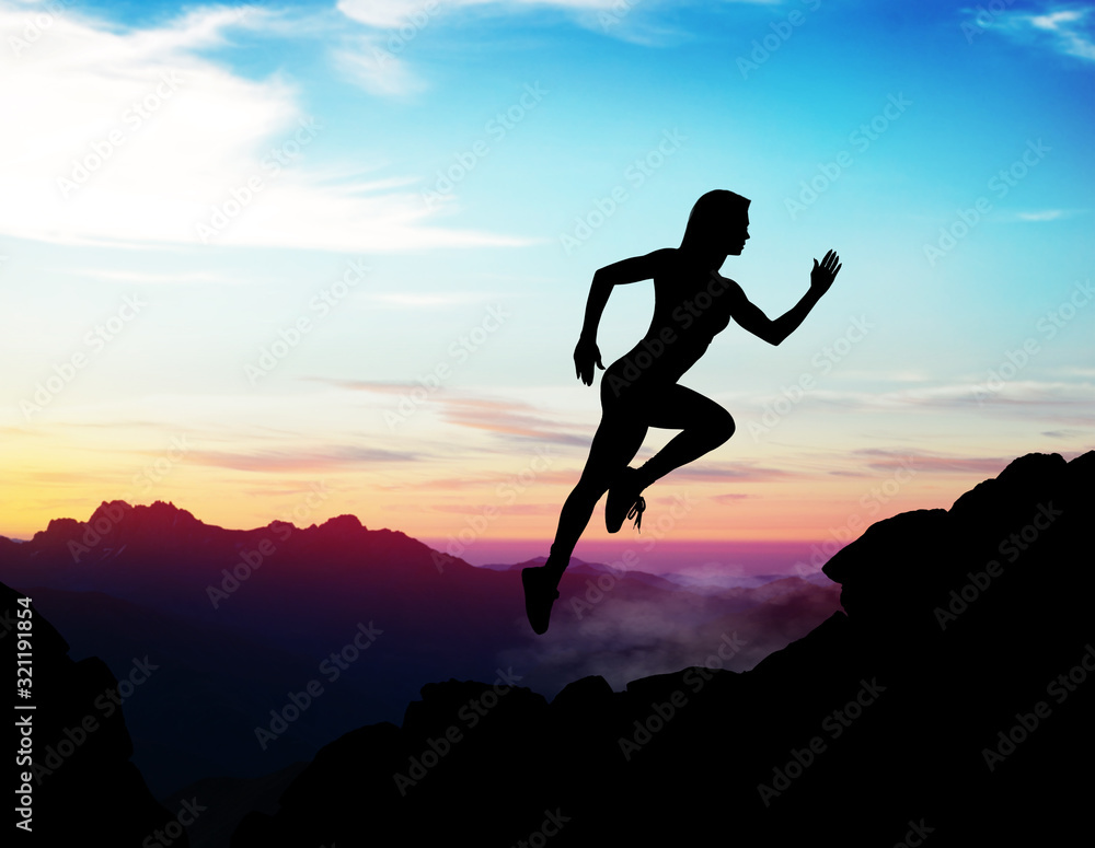 Black silhouette of woman jumps up on the rock.