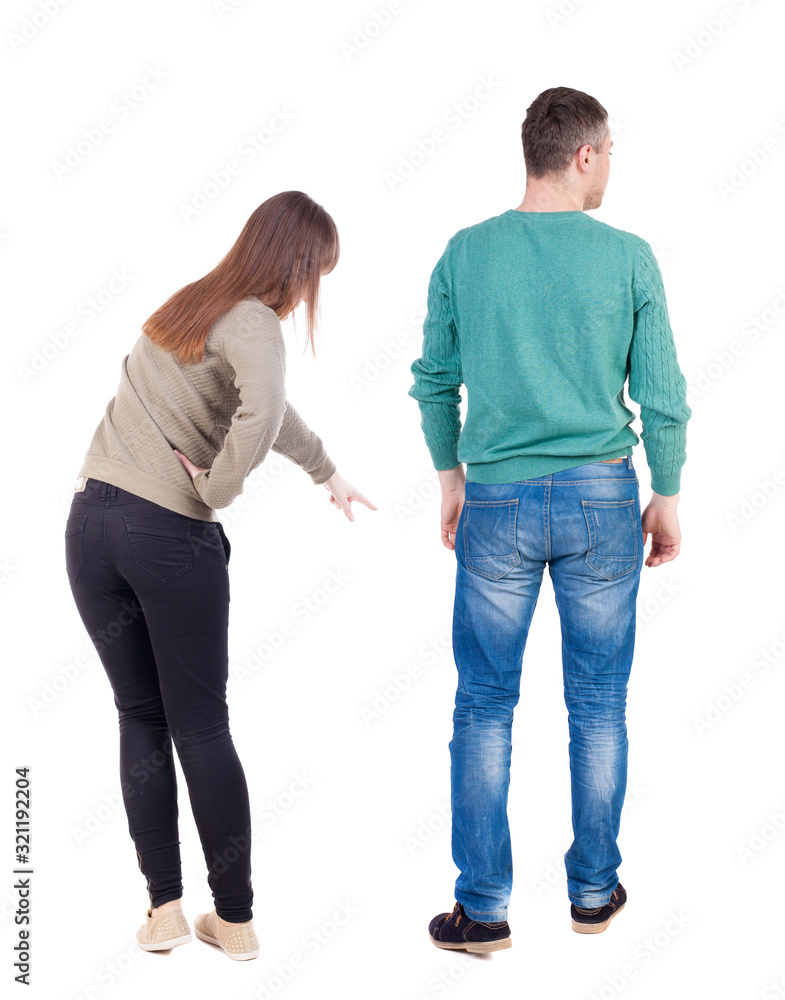 Back view of couple couple in sweater pointing. Back view of couple couple in sweater pointing.
