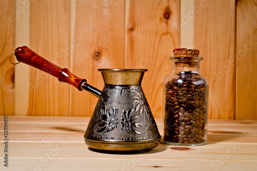 Cezve copper coffee maker with wooden handle for making coffee on an open fire. Background for the menu of restaurants, coffee houses and publications about coffee