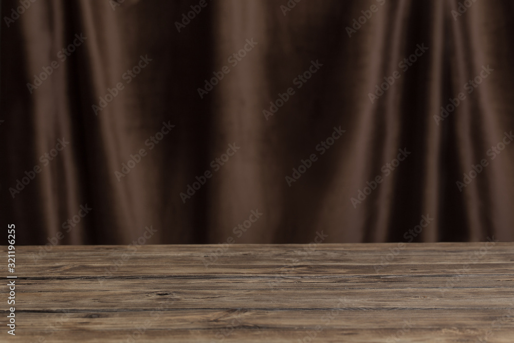 Obraz premium old wooden table on background velvet curtain