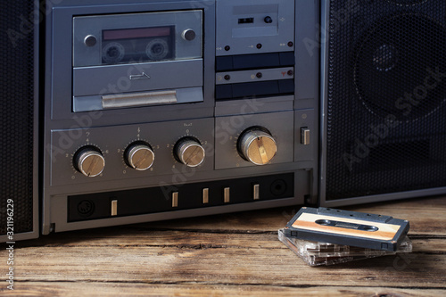 old tape recorder and cassette on  wooden table photo