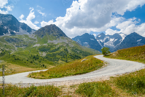 Scenic view from curve of road. Mountain La Meije and glaciers in Ecrins national park, as seen from the alpine pass col du Lautaret on a sunny summer day, Hautes Alpes, Southern French Alps, France.