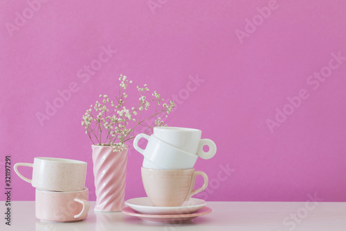 modern cups on white table on background pink wall