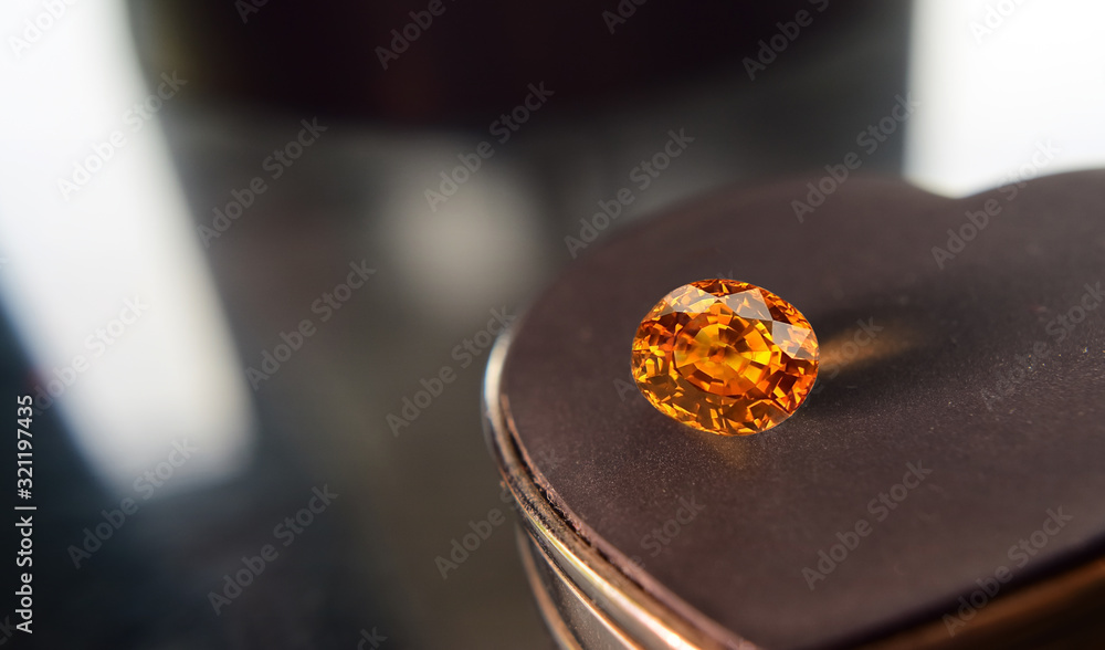  The yellow gemstone has glitter and light shadows on the floor.