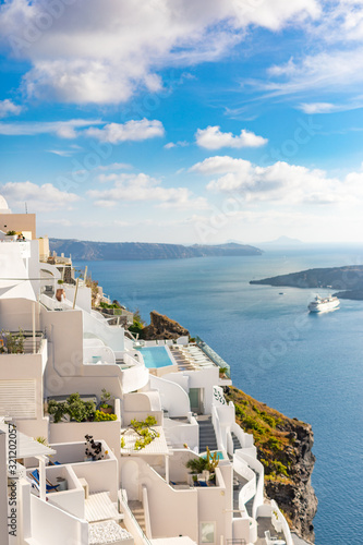 Fira capital of Santorini island and the view of volcanic caldera, Santorini, Greece. Beautiful white architecture, peaceful scenery with blue sea and sky. Summer travel vacation destination