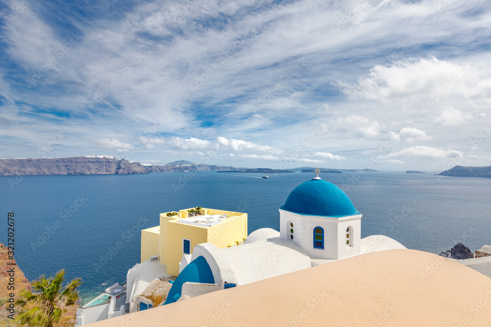 Greek church with blue dome near the sea in Oia town, Santorini island, Greece