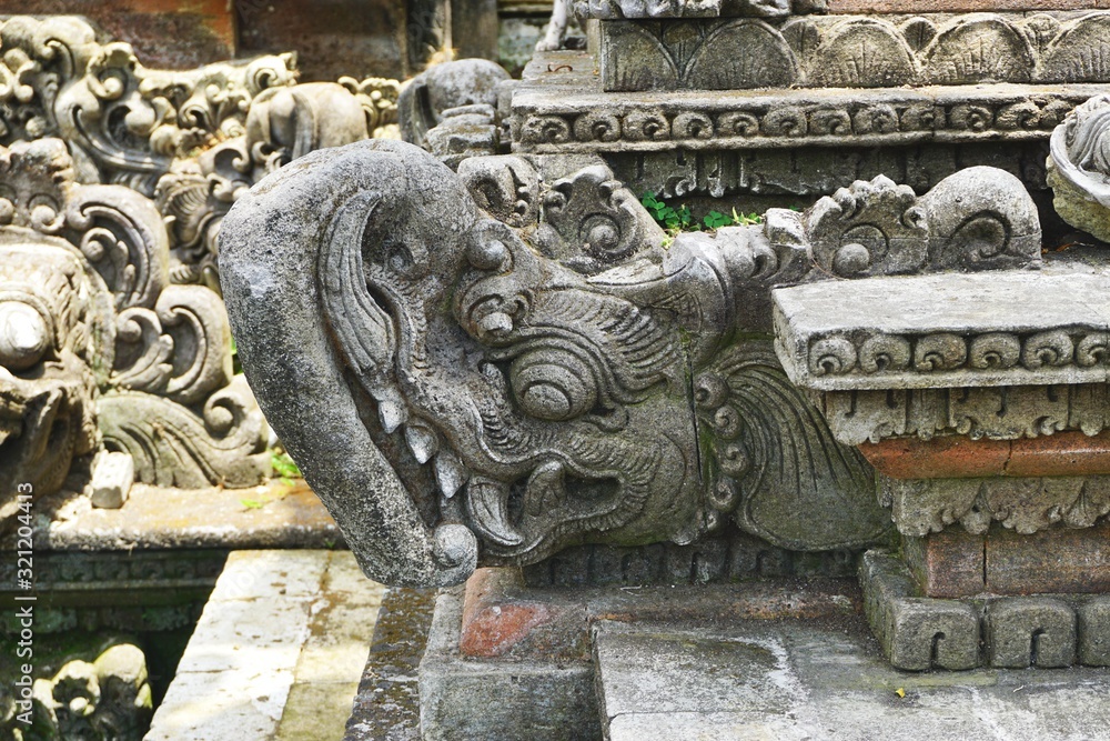 Closeup of carved stone elephant gargoyle with upturned trunk at a Hindu temple in Bali Indonesia