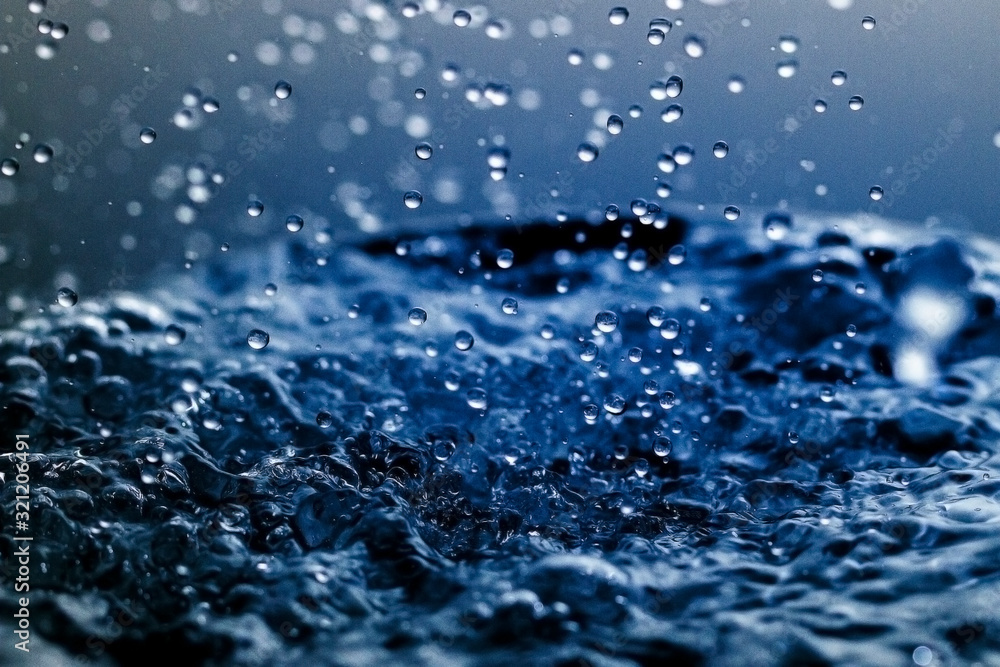 Falling water drops in frozen motion.