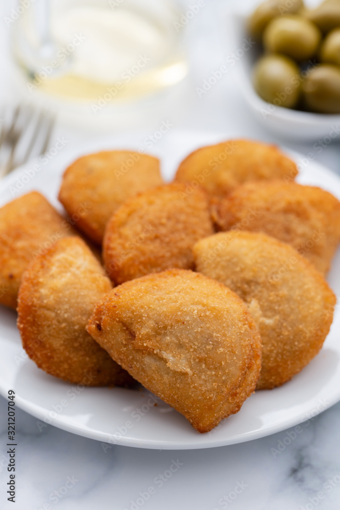 typical portuguese snack with meat rissois de carne on ceramic background