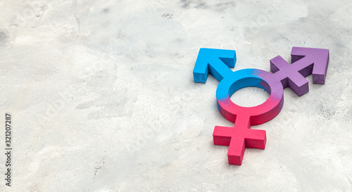 Transgender symbol and gender symbol of man and woman on a gray background photo