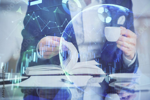 Double exposure of businessman with coffee with stock market forex chart.