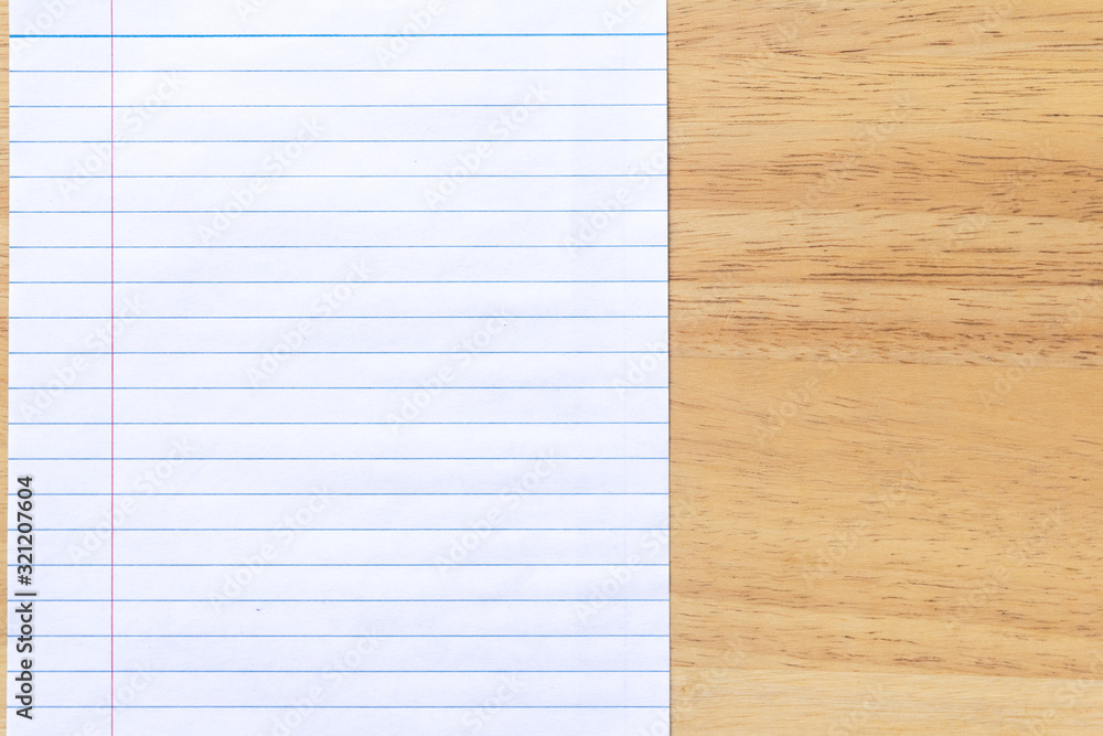 Blank line paper notebook on wood desk Blank line paper notebook on wood desk