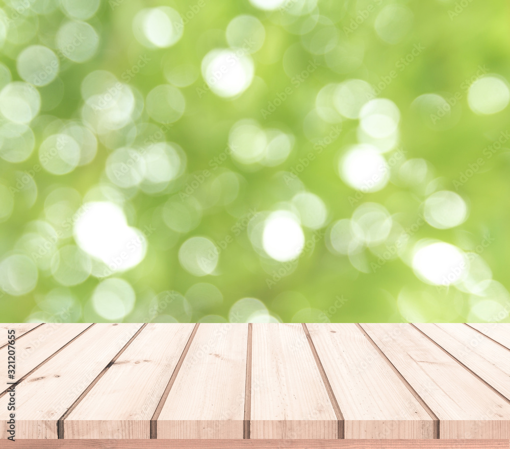 wood table with abstract green bokeh background 