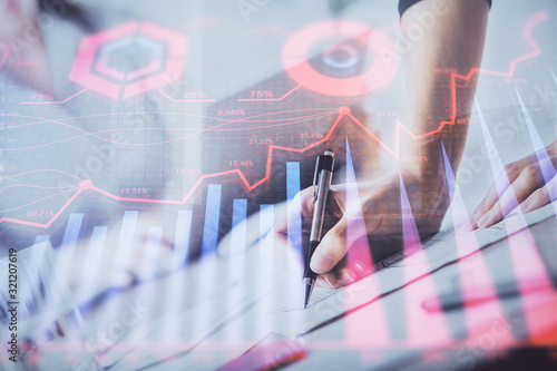 A woman hands writing information about stock market in notepad. Forex chart holograms in front. Concept of research. Double exposure © peshkova