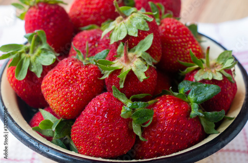 ripe red strawberry in a bowl