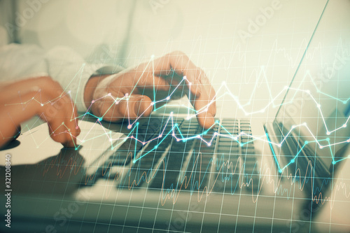 Double exposure of market chart with man working on computer on background. Concept of financial analysis.