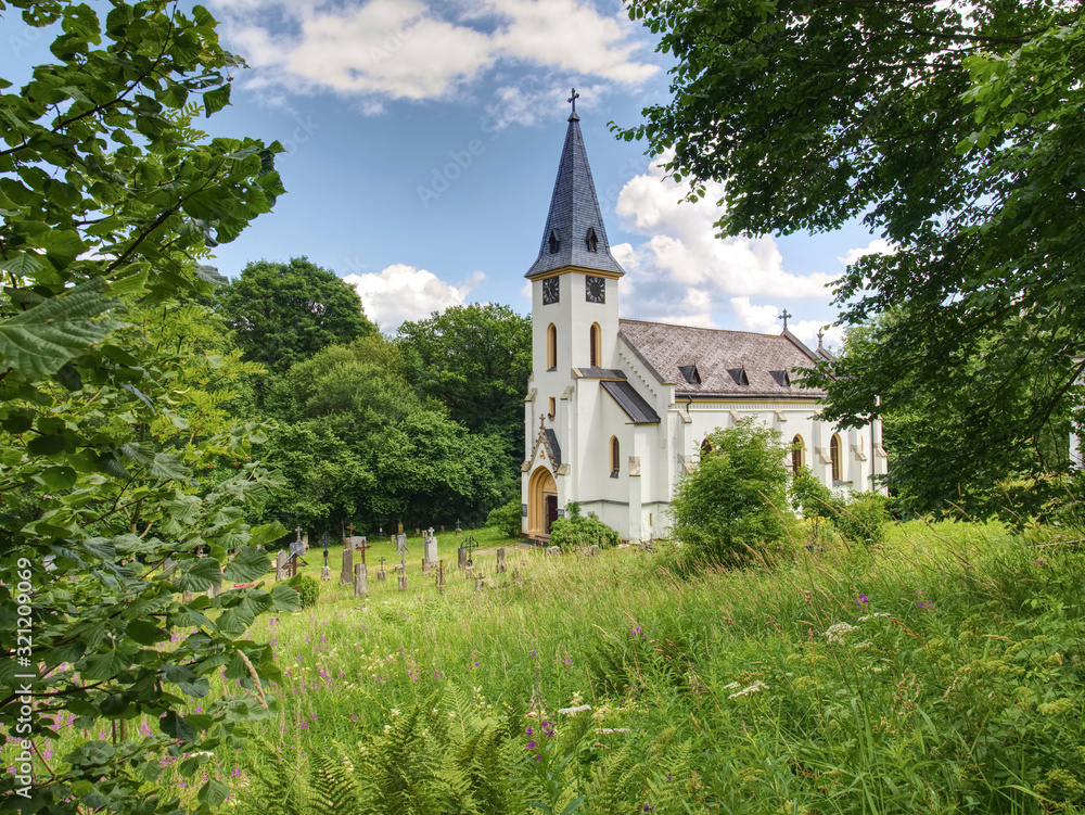 Church of st. John of Nepomuk and Graveyard, Zadni Zvonkova, Czech Republic. 15th of July 2019. Neo-Gothic building in an abandoned border village with a troubled history. Church of st. John of Nepomuk and Graveyard, Zadni Zvonkova, Czech Republic. 15th of July 2019. Neo-Gothic building in an abandoned border village with a troubled history.
