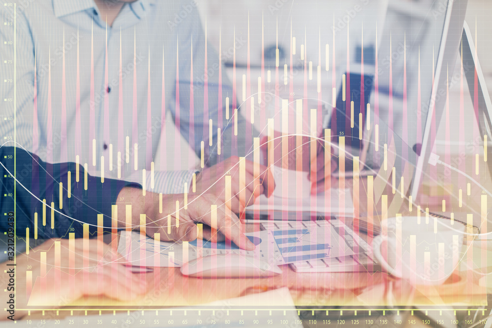 Multi exposure of chart with man typing on computer in office on background. Concept of hard work. Multi exposure of chart with man typing on computer in office on background. Concept of hard work.
