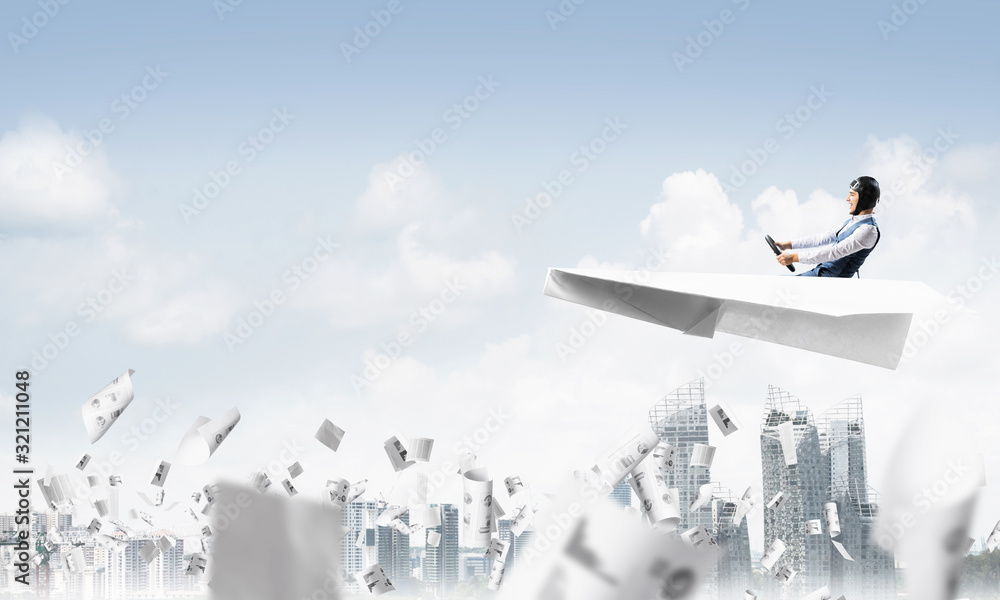 Aviator driving paper plane above business center Aviator driving paper plane above business center